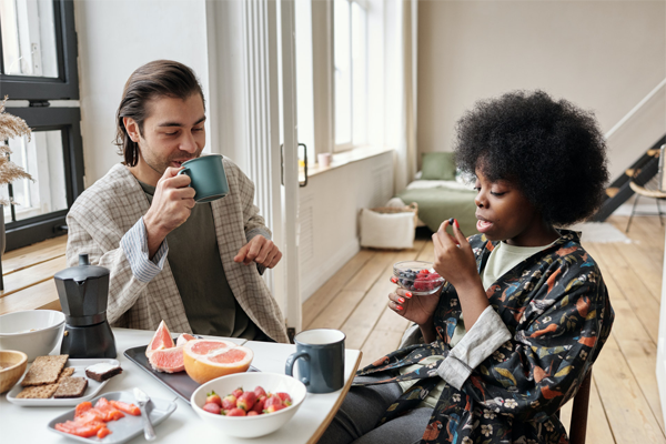 A woman and man having coffee together at a table