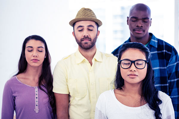 People standing with their eyes closed